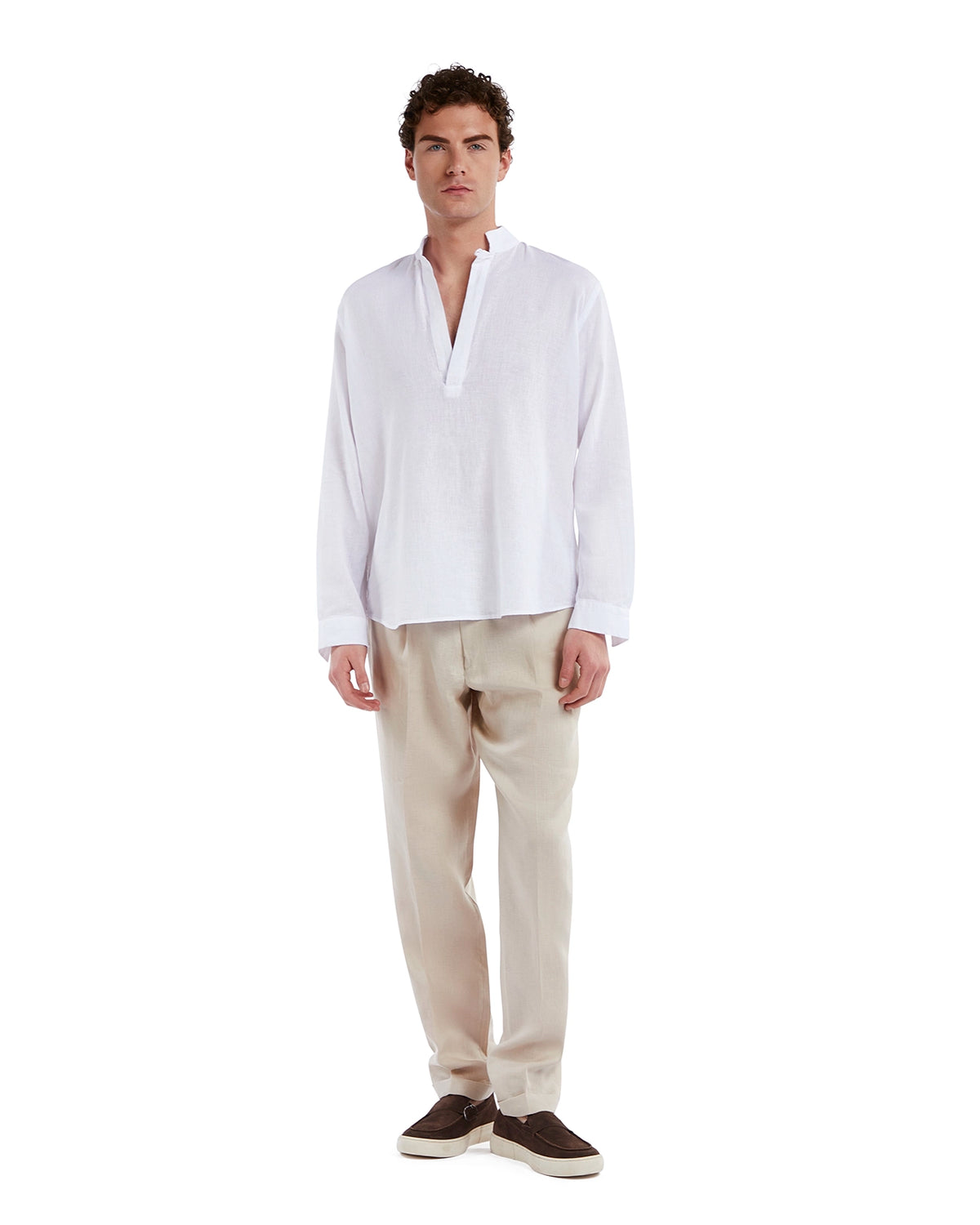 White linen long-sleeve shirt paired with beige trousers for a casual, stylish look. Perfect for warm-weather outings.