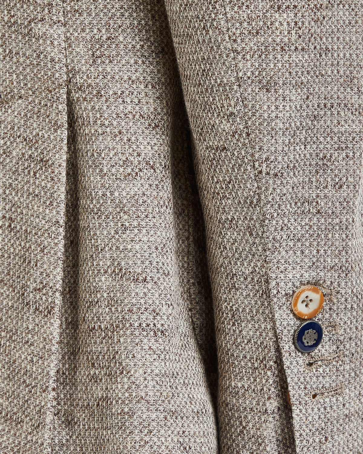 Light brown herringbone tweed blazer with contrasting buttons, perfect for casual or business attire.