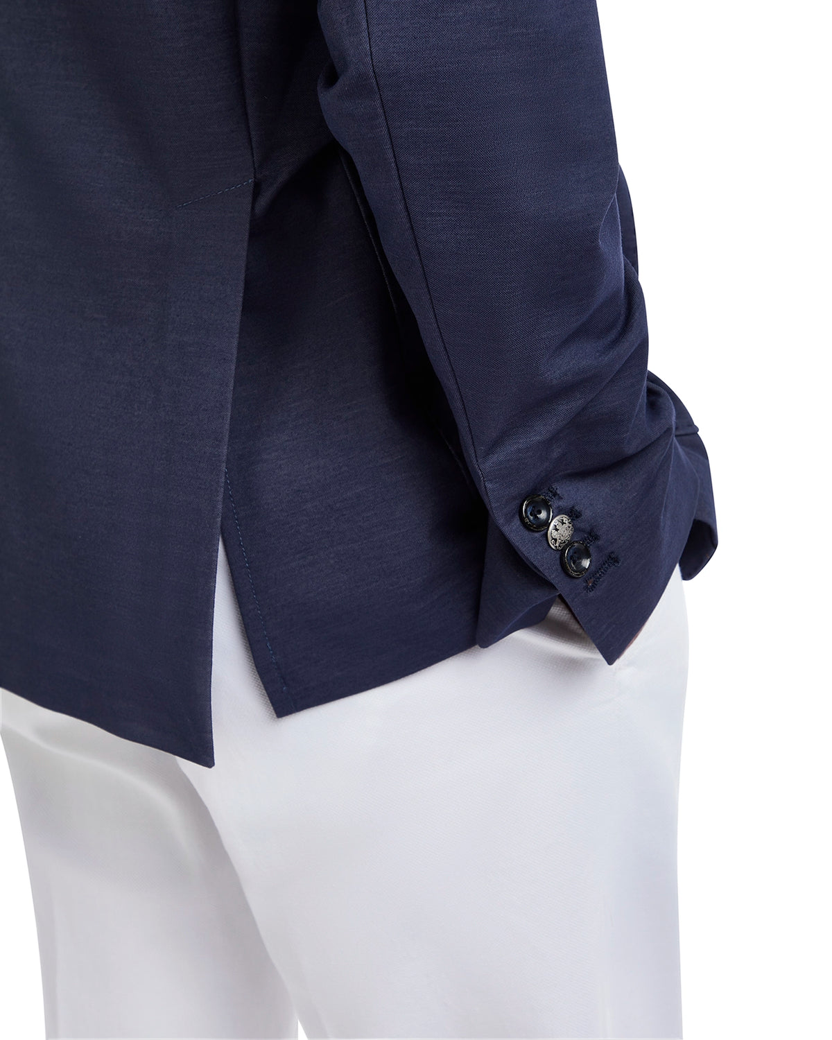 Navy blue long-sleeve shirt in lightweight fabric with button detail, paired with white trousers.