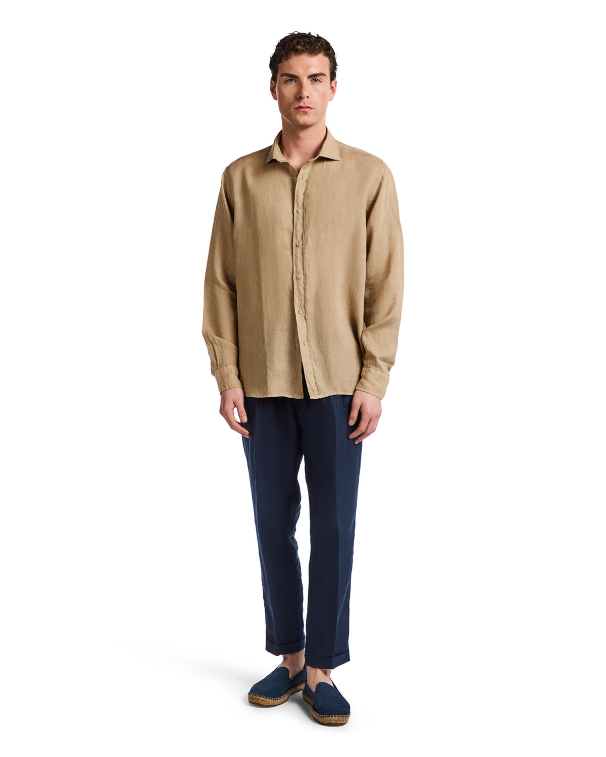 Men's beige linen shirt paired with navy chinos, styled for a casual, relaxed look. Perfect for warm weather.